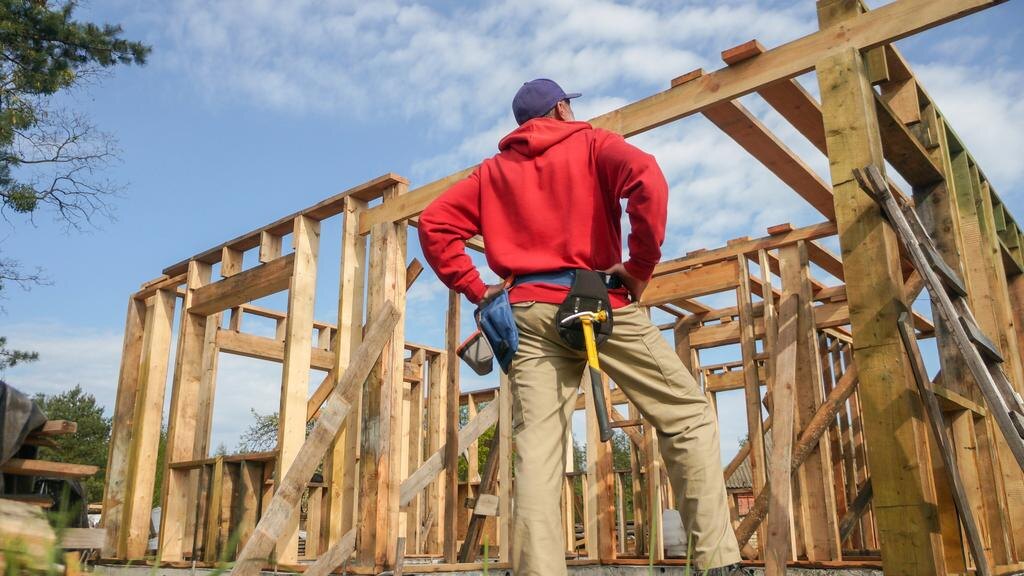 A tradie framing up a new EnableX home on the building site