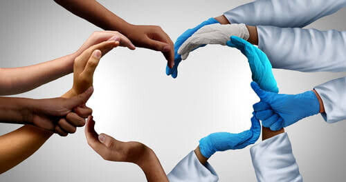 Diverse hands, including carers, forming a heart - a full circle of care